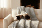 Lifestyle – hedgehog slippers on sofa with cozy blanket